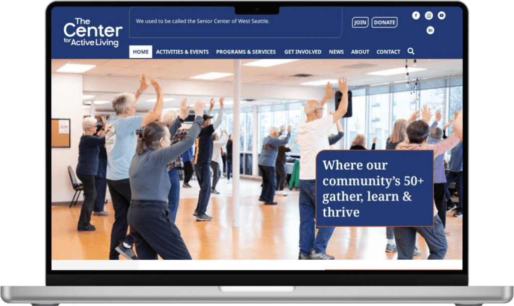 A group of adults participate in a fitness class in a bright studio, shown on The Center for Active Living website—created with expert West Seattle web design—displayed on a laptop screen.