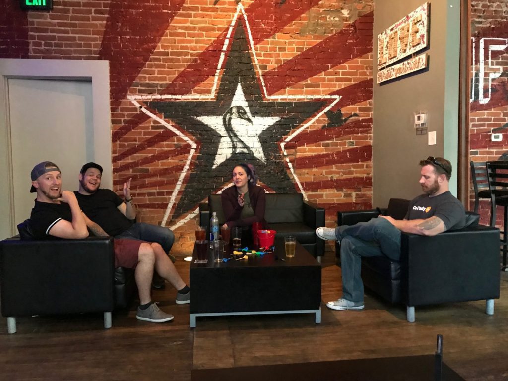 A group of people sitting in a room with a star on the wall, while a WebCami records their meeting.