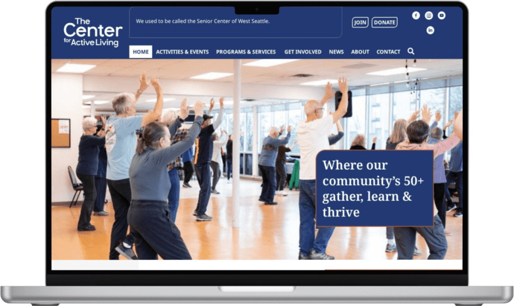 A group of adults participate in a fitness class in a bright studio, shown on The Center for Active Living website—created with expert West Seattle web design—displayed on a laptop screen.
