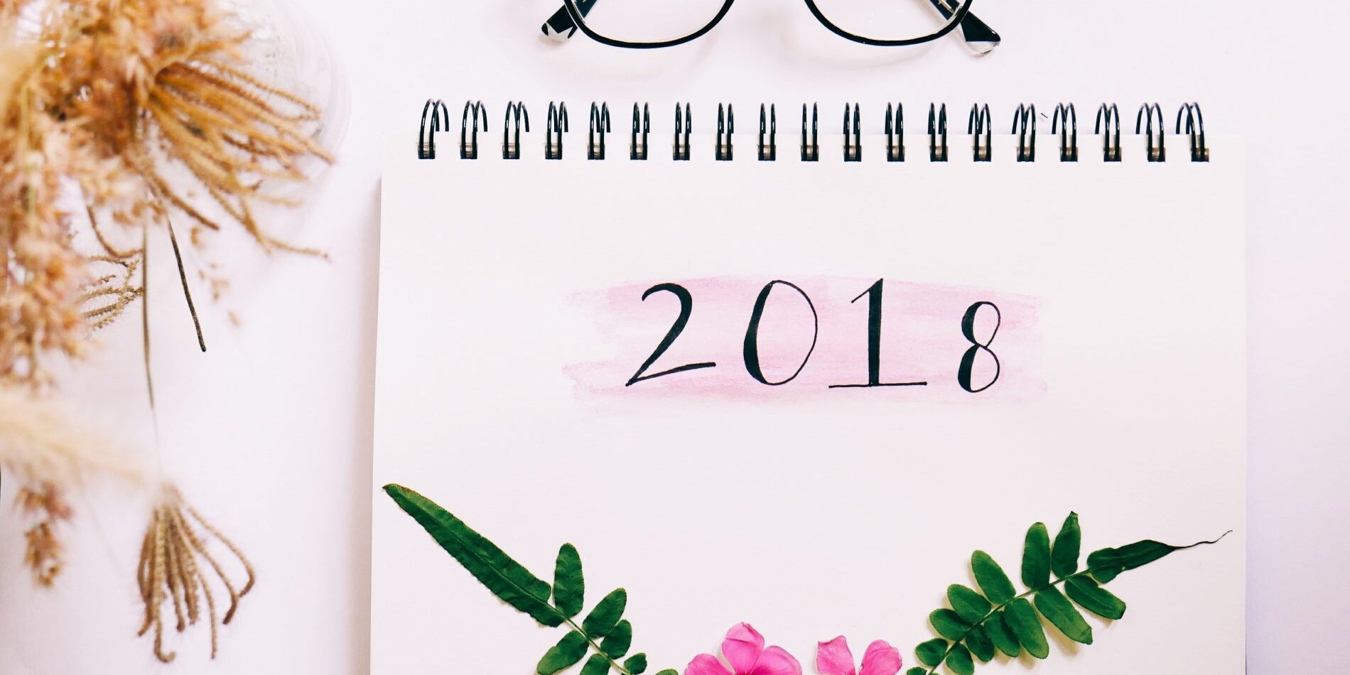 A Year in Review calendar showcasing the highlights of 2018, accompanied by a pair of glasses.