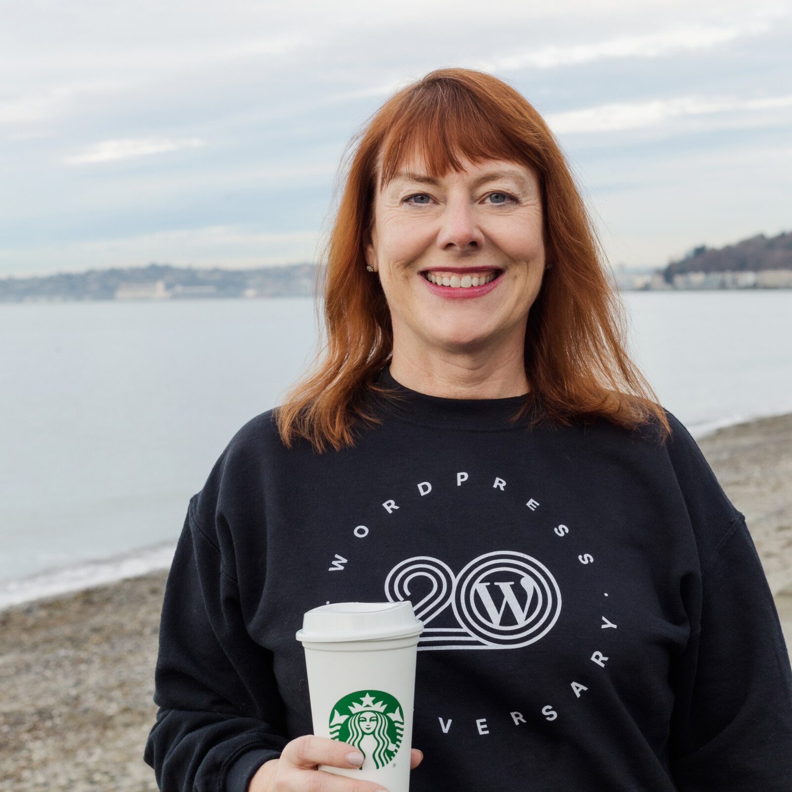 Caami enjoying a cup of coffee on a Alki Beach.