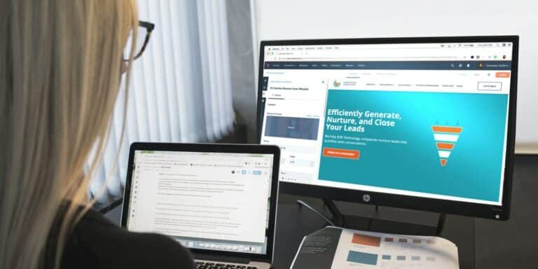 woman sitting in front of turned-on computer monitor