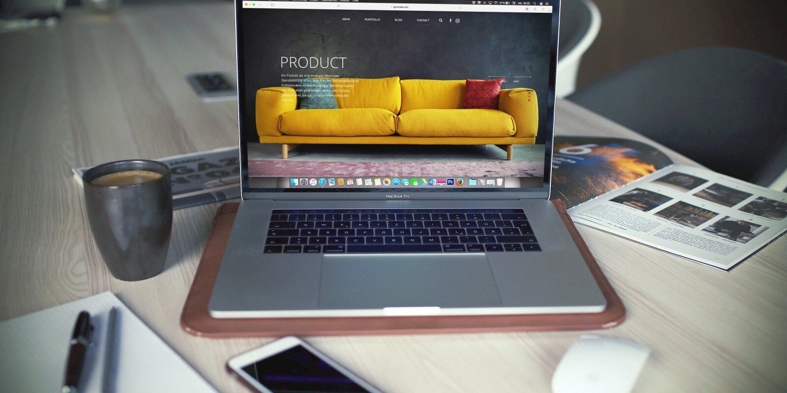 A laptop computer displaying a freelance vs agency web design comparison on a yellow couch.