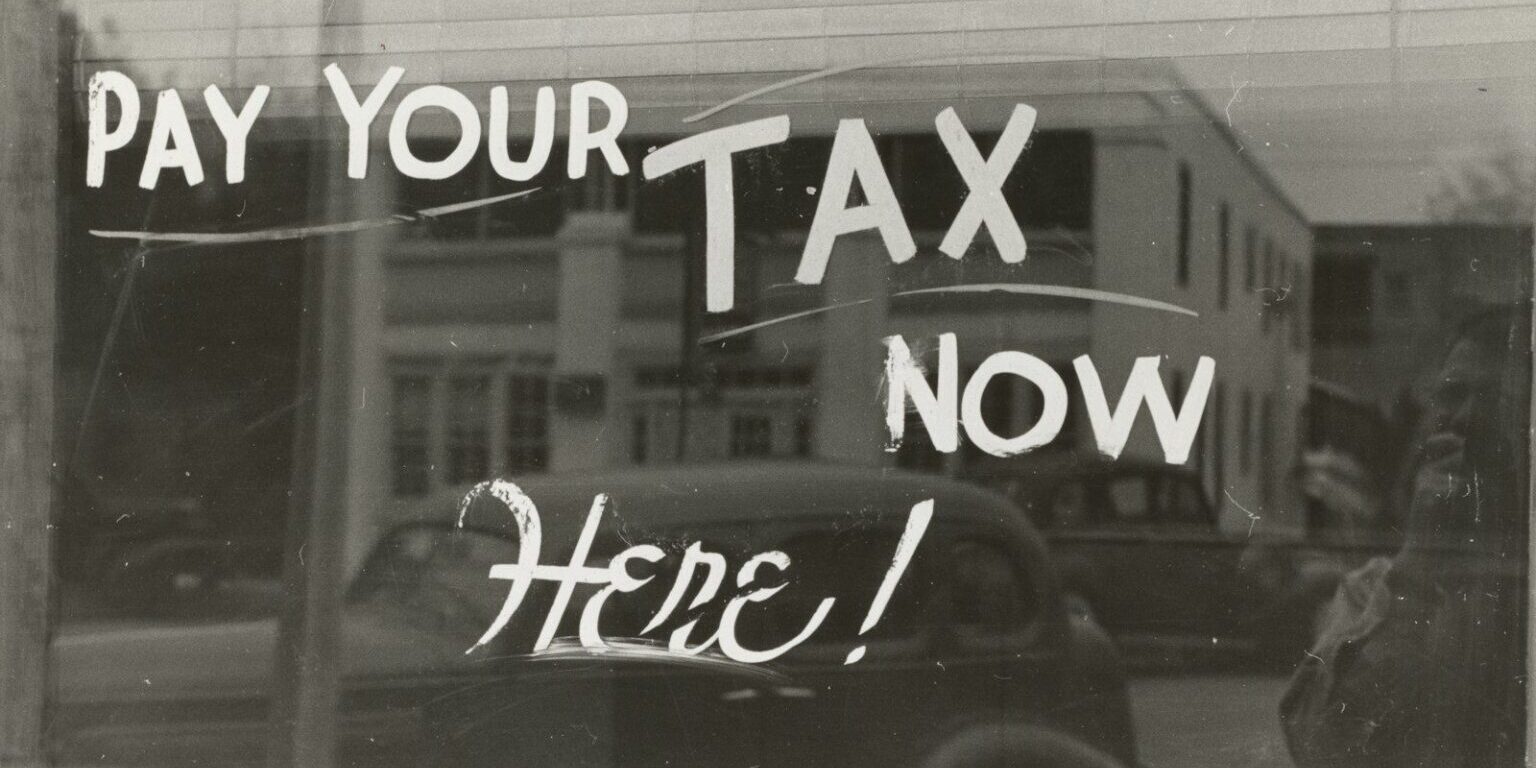 a sign that says pay your tax now here