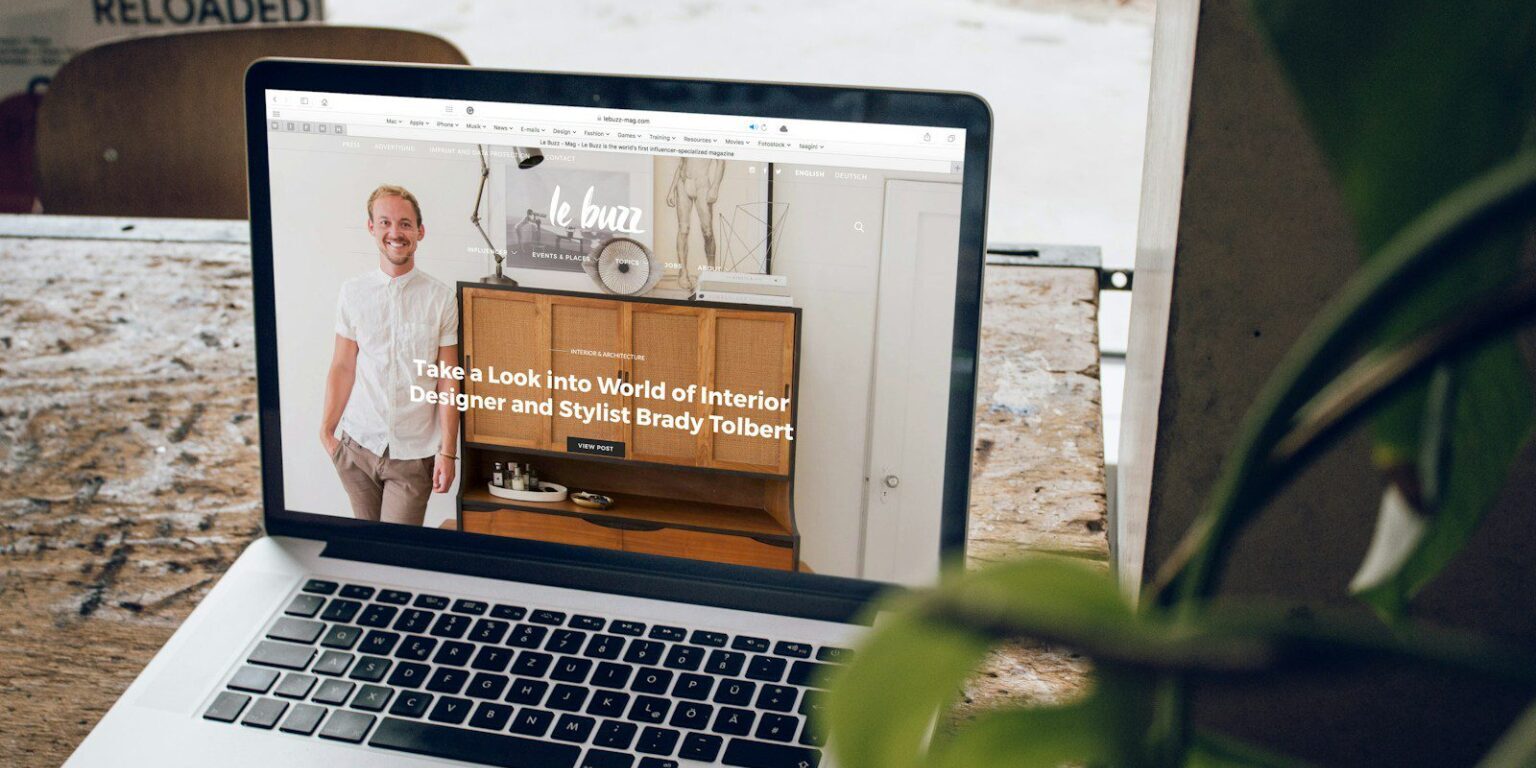 MacBook Pro on top of brown wooden table during daytime