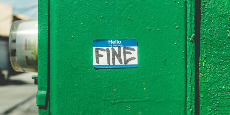 green steel box with fine-printed sticker