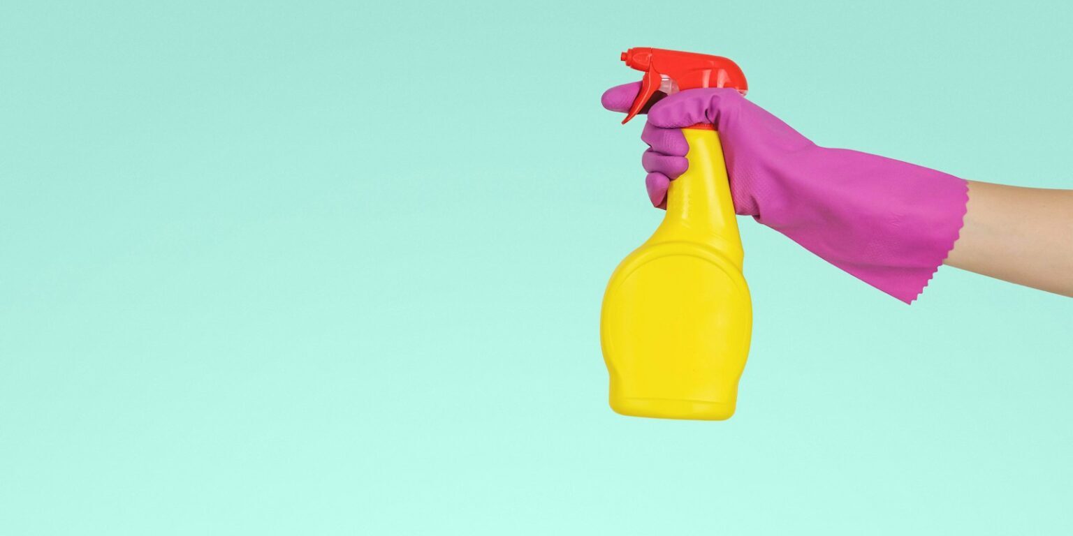 Photo by JESHOOTS.COM person holding yellow plastic spray bottle